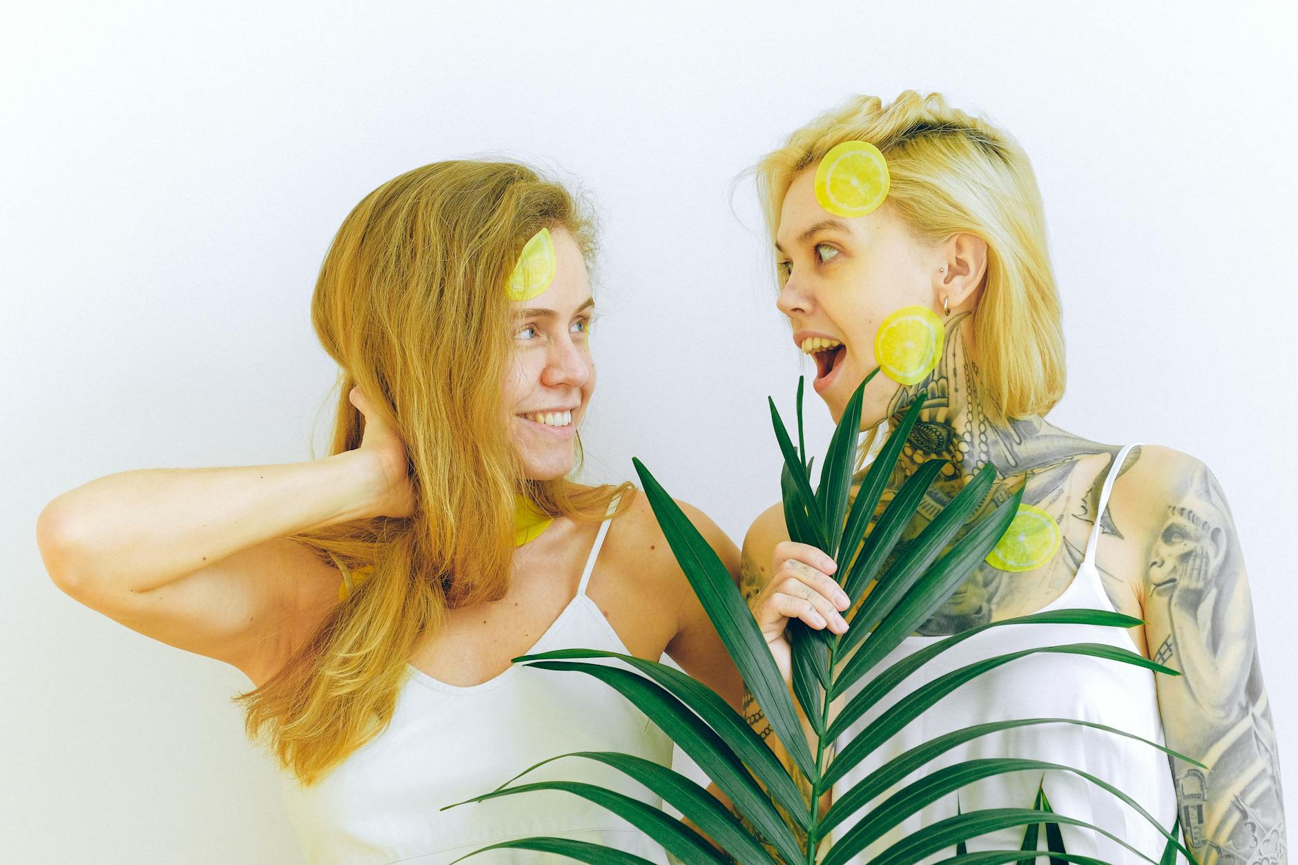 Two women laughing together in joy, expressing warmth and connection during shared intimate moments